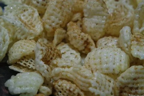 Closeup view of freshly fried chips as fast food usually eaten with tea. Stock Photos