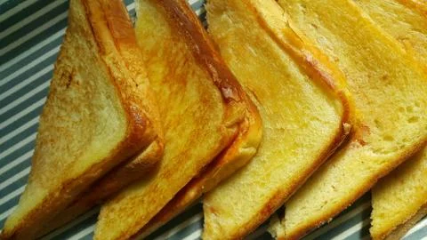Closeup view of freshly prepared half fried slices of toast bread Stock Photos