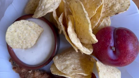Closeup view of fried chicken and chips girl dinner Stock Footage 247663170