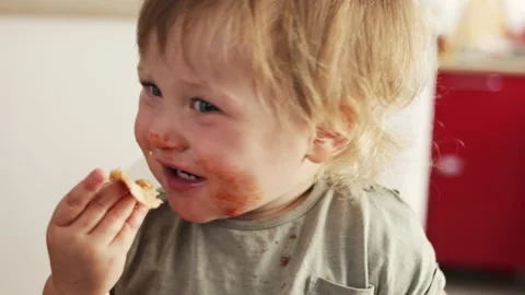 Closeup view of funny dirty small boy after eating pizza. Tomato lips and teeth 库存影片 231007345