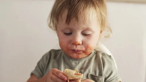 Closeup view of funny dirty small boy after eating pizza. Tomato lips and teeth Stock Footage 231582089