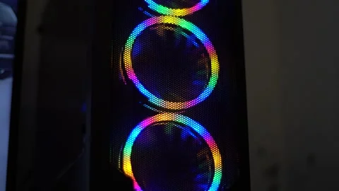Closeup view of gaming pc with three colourful cooling fans moving Stock Footage 272754449