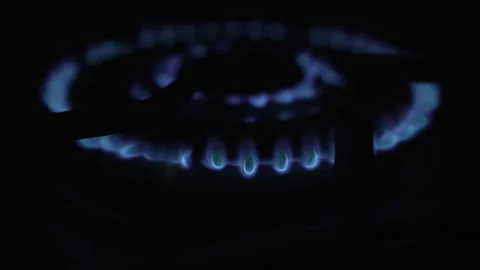 A CloseUp View of a Gas Burner Flame Emanating in Complete Darkness Surrounding Stock Footage 305267166