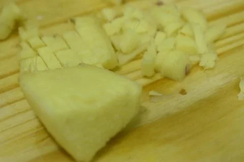 Closeup view of ginger in cutting board background. Stock Photos