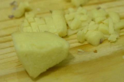 Closeup view of ginger in cutting board background. Stock Photos