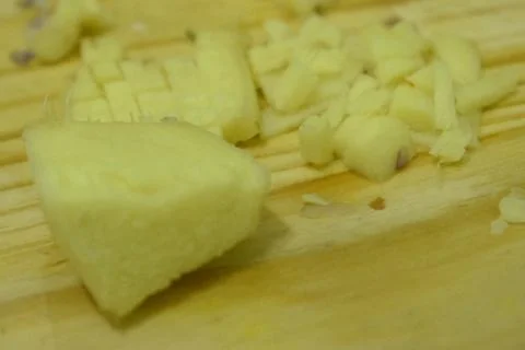 Closeup view of ginger in cutting board background. Stock Photos