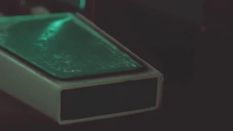 Closeup view of a green plastic object on a dark background Stock Footage 344389747