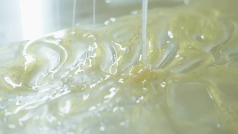 Closeup view of green transparent slime is flowing down Stock Footage 127931384