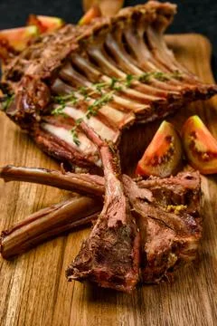 Closeup view of grilled rack of lamb on a plate with spicy sauce Stock Photos