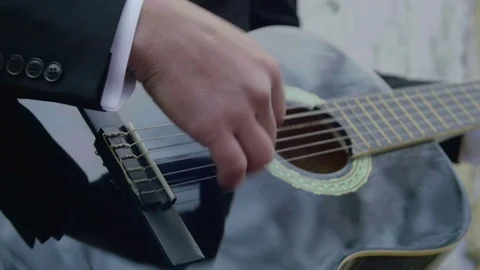 Closeup view of groom playing guitar Stock Footage 70258714