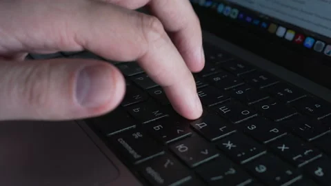 A CloseUp View of a Hand Actively Typing on a Laptop Computer Keyboard Vidéo 303829727
