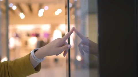 A closeup view of a hand interacting with an interactive display in a shopping Video stock 276487837