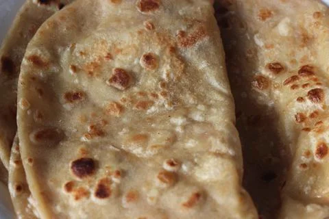 Closeup view of hand made plain bread in oil called paratha roti. Stock Photos
