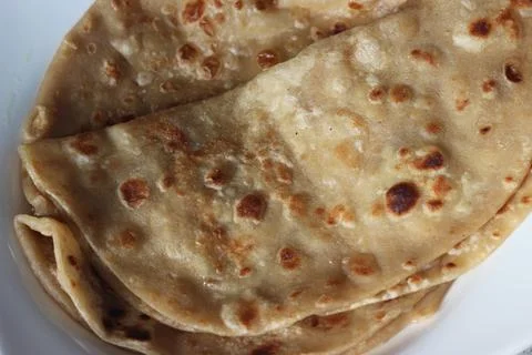 Closeup view of hand made plain bread in oil called paratha roti. Stock Photos