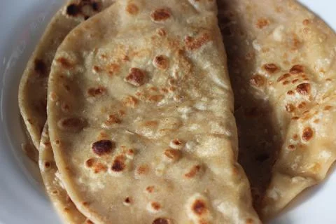 Closeup view of hand made plain bread in oil called paratha roti. Stock Photos