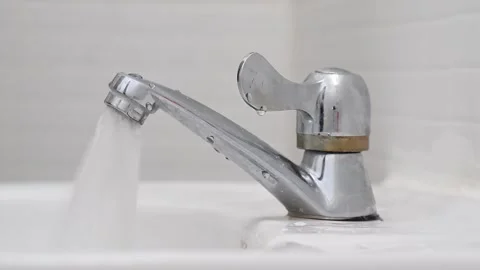 Closeup view of hand turning water tap for pouring water into sink in bathroom. Stock Footage 282907215