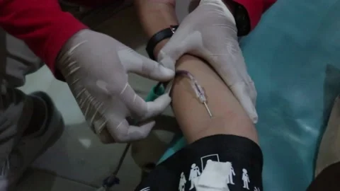 Closeup view of hand while donating his blood in clinic. Stock Footage 231456031
