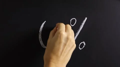 Closeup view of hand writing 0% on black chalkboard background. Stock Footage 310805635