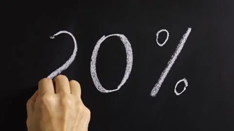 Closeup view of hand writing 20% on black chalkboard background. Stock Footage 310804195