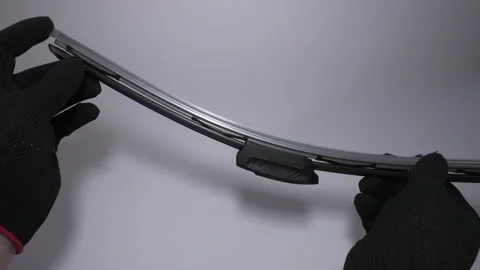 A CloseUp View of Hands Carefully Installing a Wiper Blade on a Vehicle Video stock 303812495