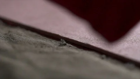 Closeup view of hands cutting cloth with a sharp knife in the workshop Stock Footage 71495530