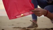 Closeup View Of Hands Lightening Before Launching Red Paper Lantern. Female Stock Footage