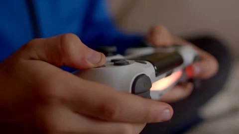 A closeup view of hands skillfully using a video game controller set against a v Stock Footage 295932157