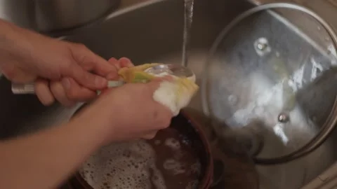 Closeup view of hands washing spoon in sink use sponge and detergent, cleaning Stock Footage 152066345