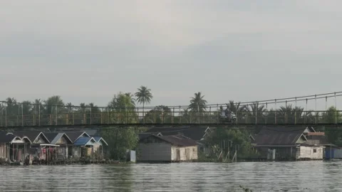 Closeup view, hanging suspension bridge over the Martapura river Stock Footage 135954534