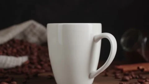 Closeup view of hot steaming black coffee being poured into white cup Stock Footage 146861944