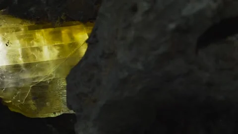 Closeup view of a huge chunk of an yellow crystal located in a cave. Stock Footage 132961889