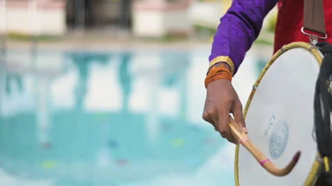 Closeup view of an Indian man playing dhol at a wedding event. Slow motion view. Stock Footage 298138837