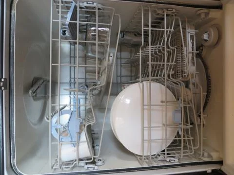 Closeup view Inside dishwasher with white dishes. Stock Photos
