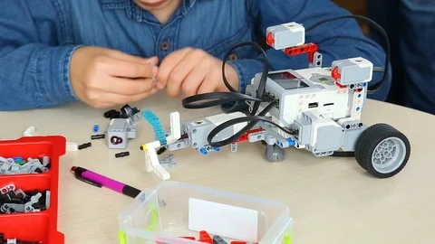 Closeup view of kid building computerized robot at robotics lesson. Editorial Stock Footage 87039281