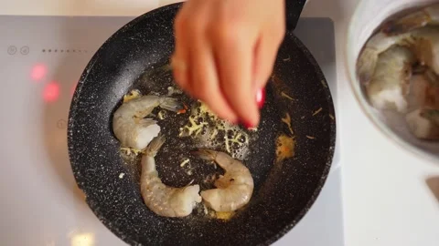 Closeup view of King prawns are fried in a pan. Frying of king shrimps on a hot Stock-Footage 151388007