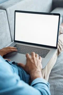 Closeup view on laptop white empty blank screen with male hand on keyboard Stock Photos