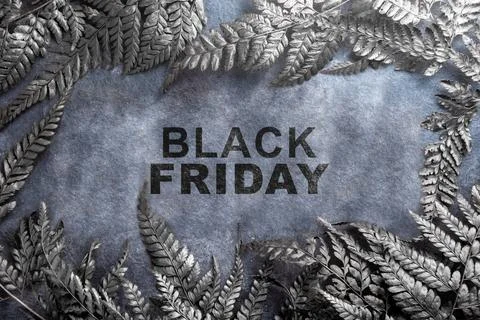 Closeup view of leaf frame with Black Friday text on a black background. Fl.. Stock Photos