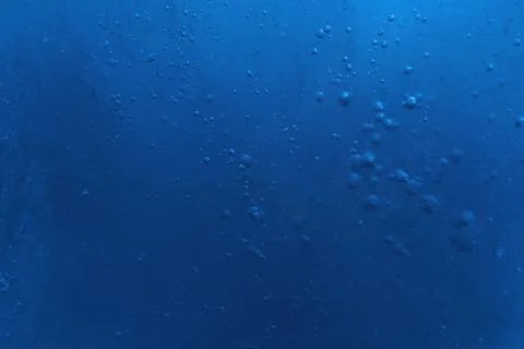 Closeup view of light blue crystal clear ice cube as background. Color tone.. Foto stock