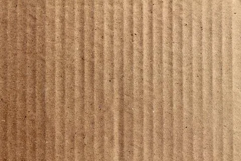 A closeup view of the lines and the dots of a beige cardboard box pattern bac Stock Photos