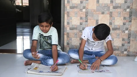 Closeup view of little 10 years old kids reading Indian news paper at home. Stock Footage 130898335
