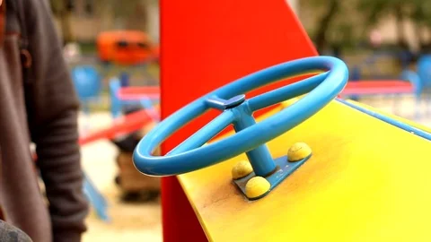 Closeup view of little boy hands driving big toy car helm outside on modern 스톡 동영상 118690763
