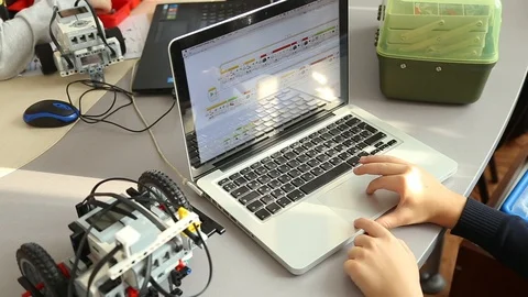 Closeup view of little hands of one kid programing robot Video stock 87038843
