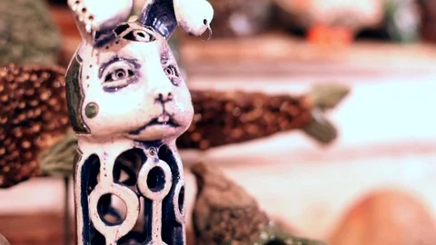 Closeup view of little rabbit statuette with three eyes and long ears standing Vidéo 116378464