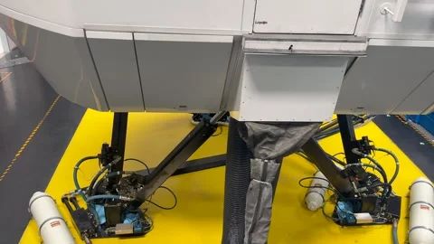 Closeup View of the Lower Part of an Old Full-Motion Flight Simulator in Stock Footage 337573332