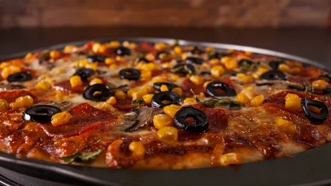 Closeup view of making a pizza with ingredients appearing on baking plate 動画素材 73917069