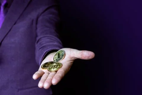 Closeup view of man with different bitcoins. Stock Photos