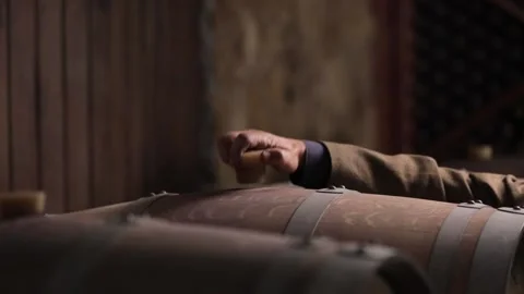 Closeup view of a man extracting wine from a barrel. Stock Footage 132969468