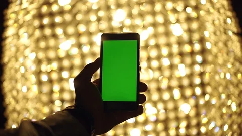 Closeup view of man hand using modern smart phone with green screen mobile on Stock Footage 99689470