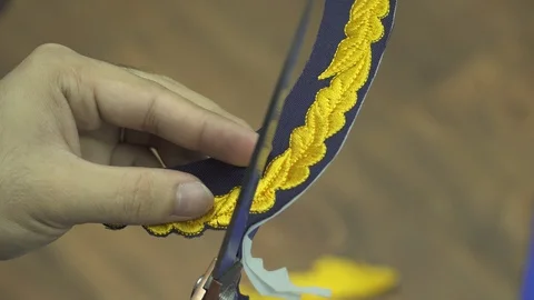 Closeup View Of man Hands Cutting logo From Clothes With Scissors. 스톡 동영상 107660856