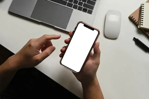 Closeup view of man using smartphone at working desk. Blank screen for your Foto stock